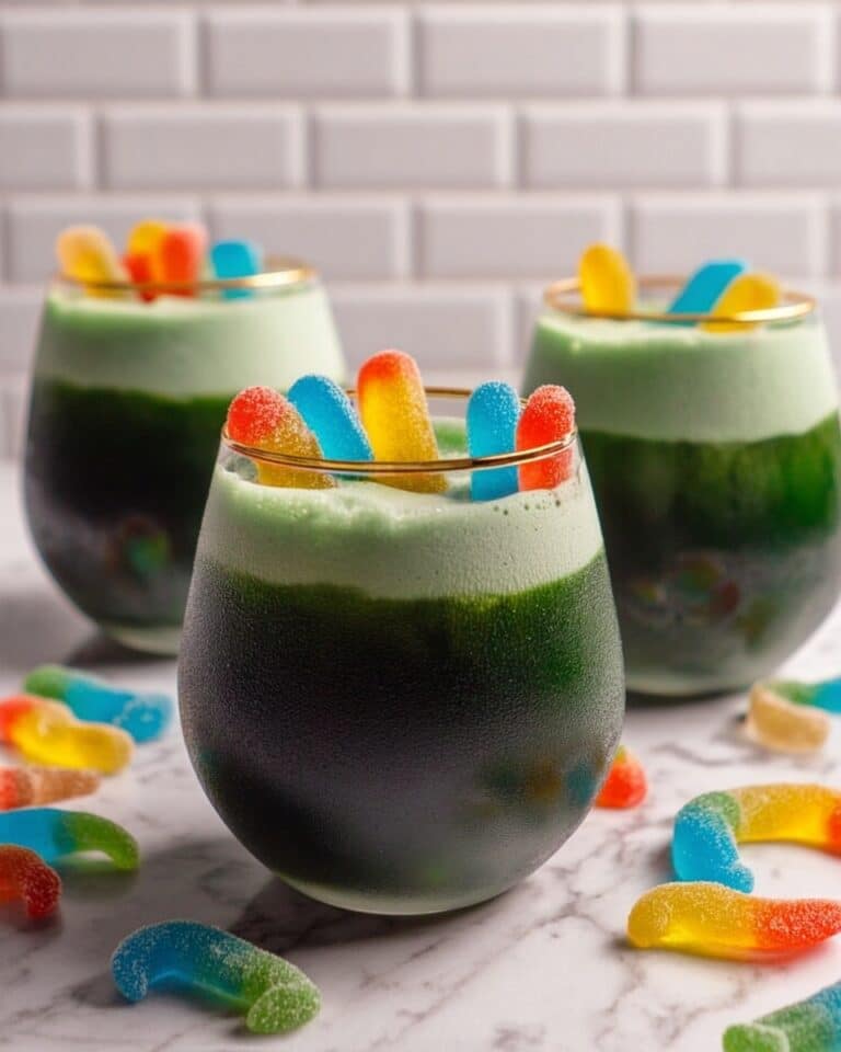 Toxic Waste Halloween Punch with Green Foam and Gummy Decorations Recipe