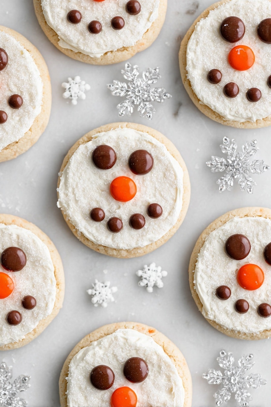 Snowman Face Cookies, festive holiday cookies, easy winter cookies, Christmas cookie ideas, kid-friendly holiday treats - Several round cookies are arranged on a white marbled surface, each having two layers: a light golden cookie base and a thick, even layer of white frosting with a sugar crystal texture on top. On every cookie, chocolate candies form two eyes and a smiling mouth shape, while an orange candy is placed at the center to represent a nose. Clear plastic snowflake decorations and tiny white snowflake sprinkles are scattered around the cookies, enhancing the wintry theme. photo taken with an iphone --ar 2:3 --v 7