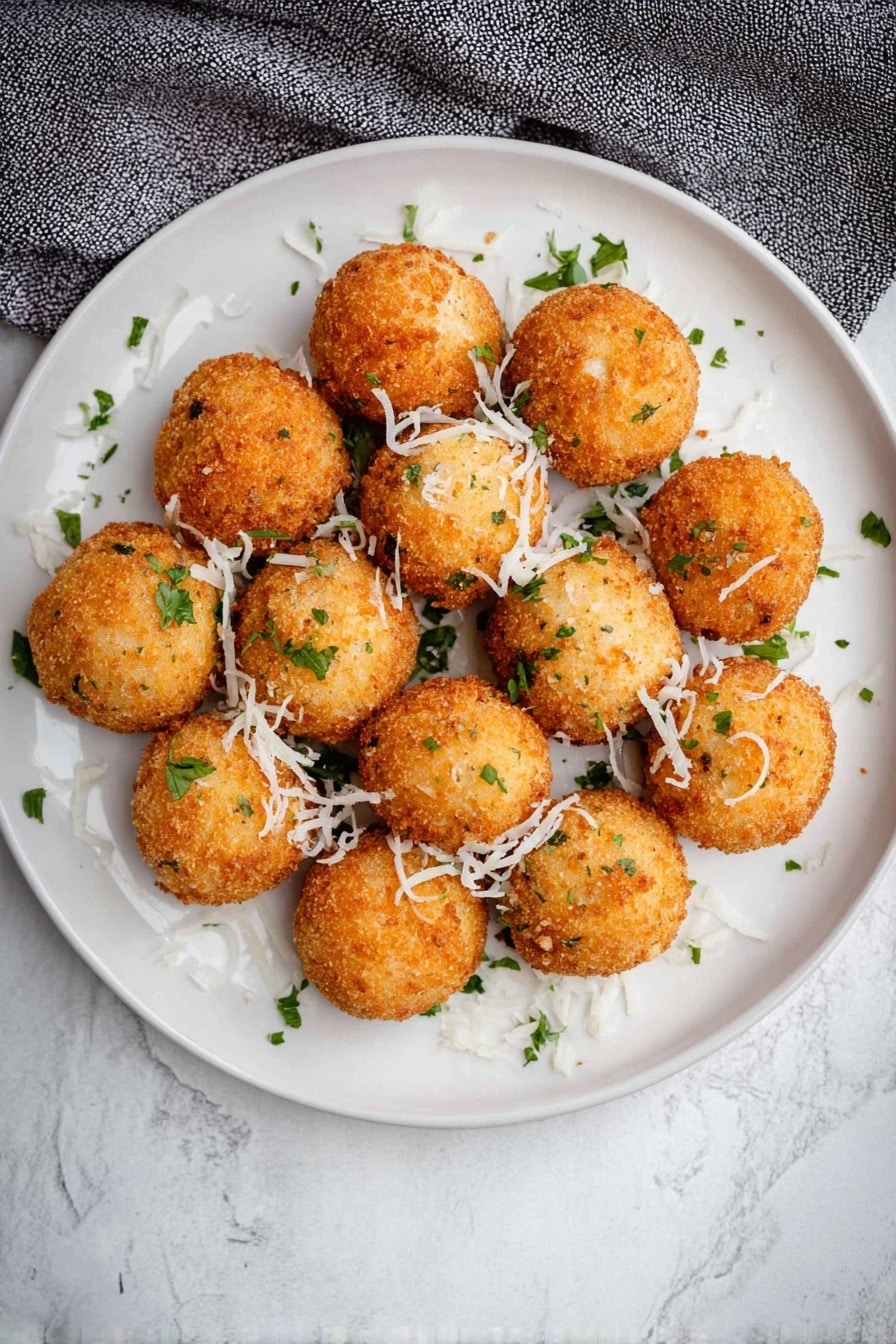 Cheddar & Green Onion Mashed Potato Balls, crispy cheesy potato bites, cheesy potato appetizers, quick mashed potato snacks, savory potato balls - A close view of one bright golden brown fried ball being pulled apart by two woman's hands, revealing a soft, cheesy white inside with bits of green herbs mixed in, and a slight stringy cheese pull between the two halves. In the background, many more similar golden brown fried balls with small green herb pieces are scattered on a white plate, all set on a white marbled surface. photo taken with an iphone --ar 2:3 --v 7