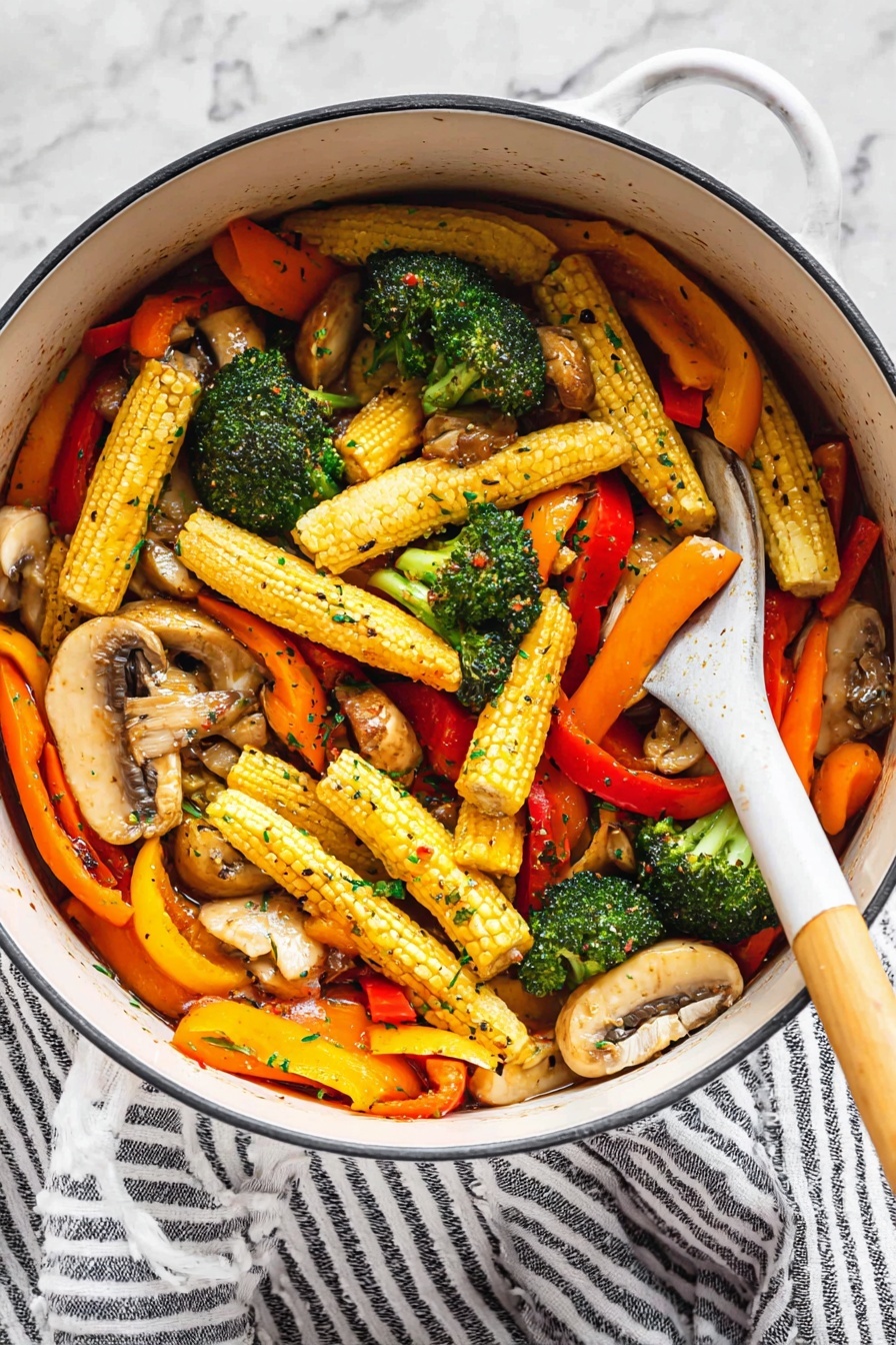 Vegetable Stir Fry, healthy vegetable stir fry, quick vegetable stir fry, colorful stir fry recipe, easy vegetable stir fry - A white pot holds a colorful mix of vegetables with three main layers: at the bottom are light brown sliced mushrooms with a tender texture, the middle layer shows bright green broccoli florets with a slightly rough surface, and the top layer is filled with long baby corn with a yellow bumpy surface, bright orange carrot slices, and strips of red and yellow bell peppers, all glistening with a light sauce and sprinkled with small green herb flakes and black pepper. A white spoon with a wooden handle is resting inside the pot, partly lifting some of the vegetables. The pot sits on a white marbled surface next to a white and black striped cloth. Photo taken with an iphone --ar 2:3 --v 7