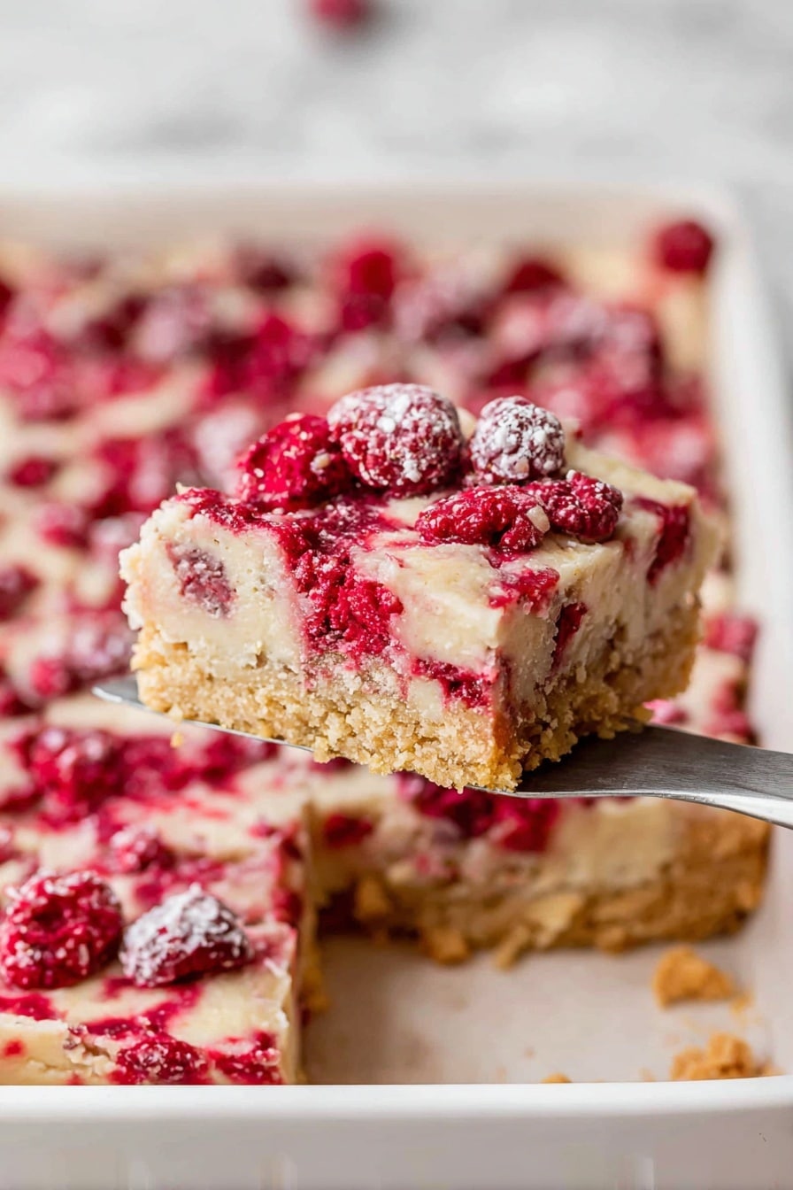 Cranberry Christmas Cake, festive cranberry cake, holiday dessert recipes, easy holiday cake, winter fruit cake - A square piece of dessert with three clear layers is being lifted by a spatula. The bottom layer is a golden, crumbly crust with a slightly rough texture. The middle layer is smooth and pale beige, forming a solid base. The top layer is a mix of bright red berries scattered inside a light, creamy topping that has a soft, slightly uneven texture with small bubbles and a dusting of sugar crystals. The dessert sits in a white baking pan, and the background shows the rest of the dessert still inside the pan, all placed on a white marbled surface. photo taken with an iphone --ar 2:3 --v 7