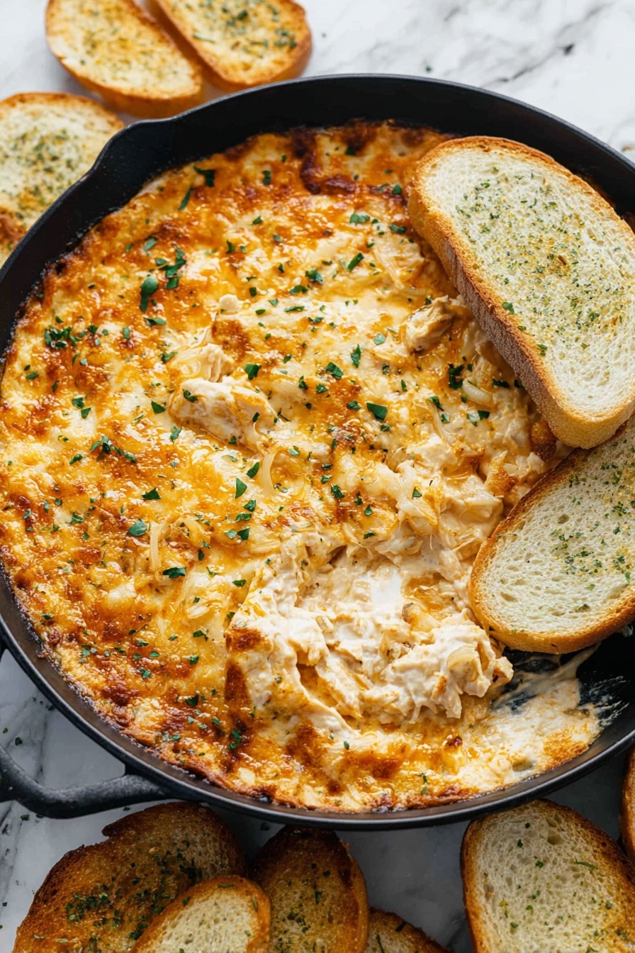 Tennessee Onion Dip, Southern onion dip, caramelized onion appetizer, cheesy onion dip, party appetizer recipes - A black skillet is filled with a creamy, baked dip that has a golden brown top layer of melted cheese mixed with small bits of onions and herbs. The top layer looks slightly crispy and browned in spots, with green parsley sprinkled over it. One side of the dip is scooped out slightly, showing the soft, cheesy, and chunky middle layer beneath. On the right edge of the skillet, there are several toasted bread slices partially dipped into the cheese mixture. More toasted bread slices are scattered around the skillet on a white marbled surface. photo taken with an iphone --ar 2:3 --v 7