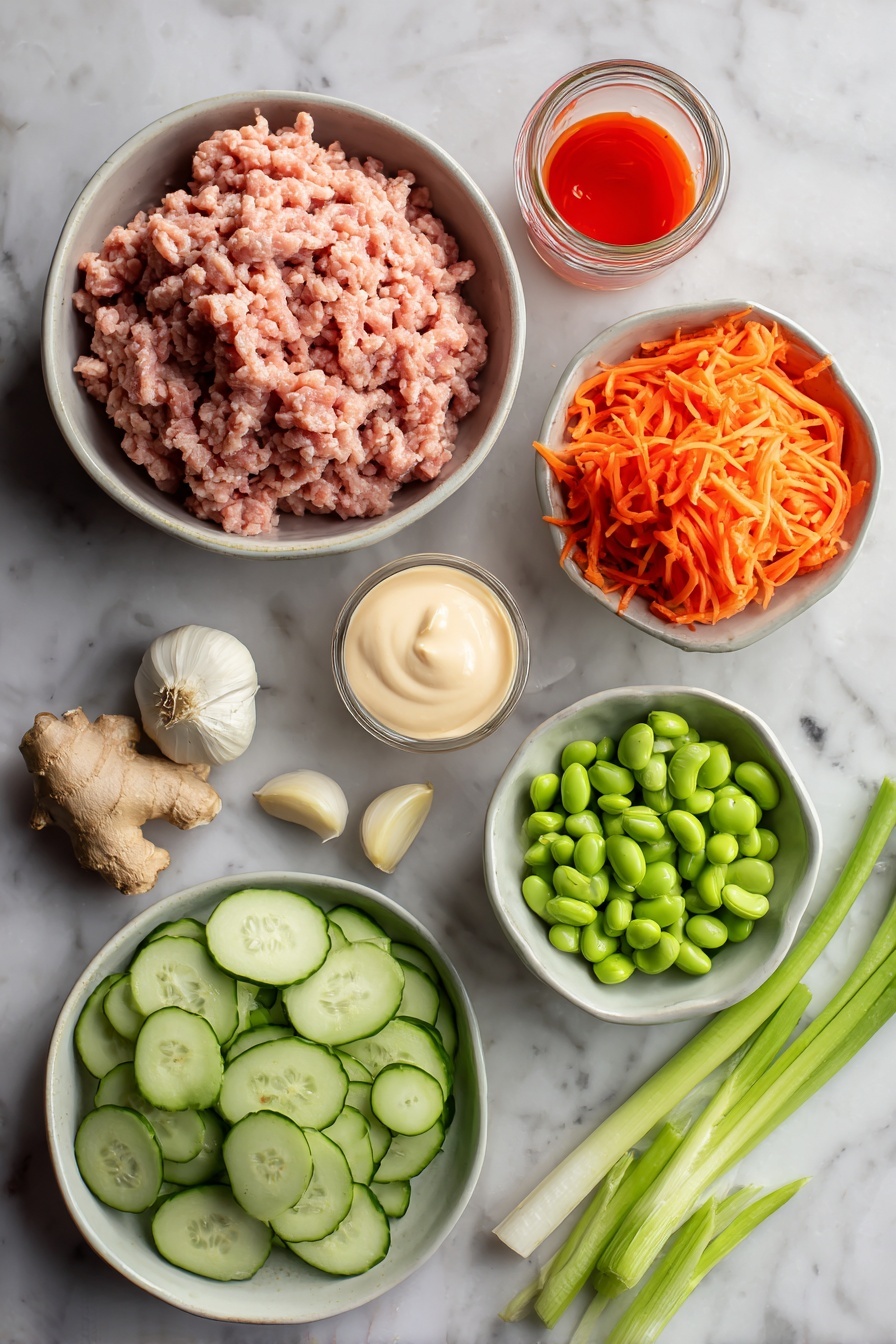 Ground Turkey Rice Bowls with Bang Bang Sauce, easy ground turkey dinner, healthy turkey rice bowls, quick weeknight dinner recipes, flavorful bang bang sauce - Flat lay of ground turkey raw and fresh, peeled garlic cloves, fresh ginger root with a small piece grated, bright orange shredded carrots, sliced green onions with vibrant green tops, sliced avocado with creamy green flesh, shelled edamame beans, small jar of creamy mayonnaise, and a small bowl of bright red sweet chili sauce with sriracha drizzle, all placed on a white marble surface, photo taken with an iphone --ar 2:3 --v 7