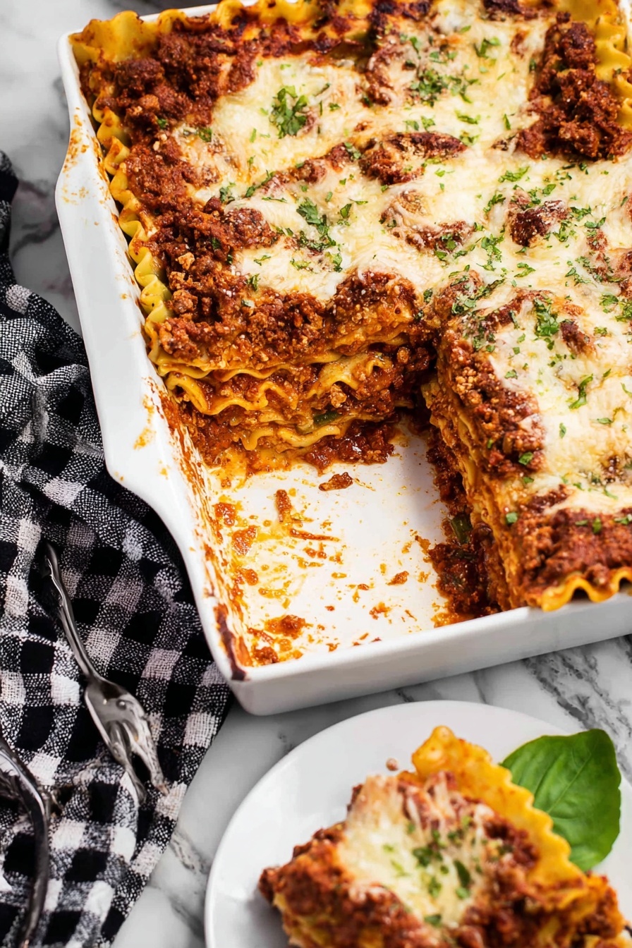 Cheesy Bolognese Lasagna, cheesy lasagna recipe, baked lasagna with bolognese, easy cheesy lasagna, Italian comfort food - A white rectangular dish filled with lasagna is shown, with one large piece taken out. The lasagna has several visible layers including a rich, dark red meat sauce, pale yellow pasta sheets with ruffled edges, and melted white cheese with a slightly browned top. The meat sauce layer appears thick and textured, while the cheese is spread unevenly and speckled with small green herb bits. A white plate on the side holds a small piece of lasagna, resting on a green leaf, with a silver fork nearby. The dish is placed on a white marbled surface with a black and white checkered cloth partially visible next to it. Photo taken with an iphone --ar 2:3 --v 7