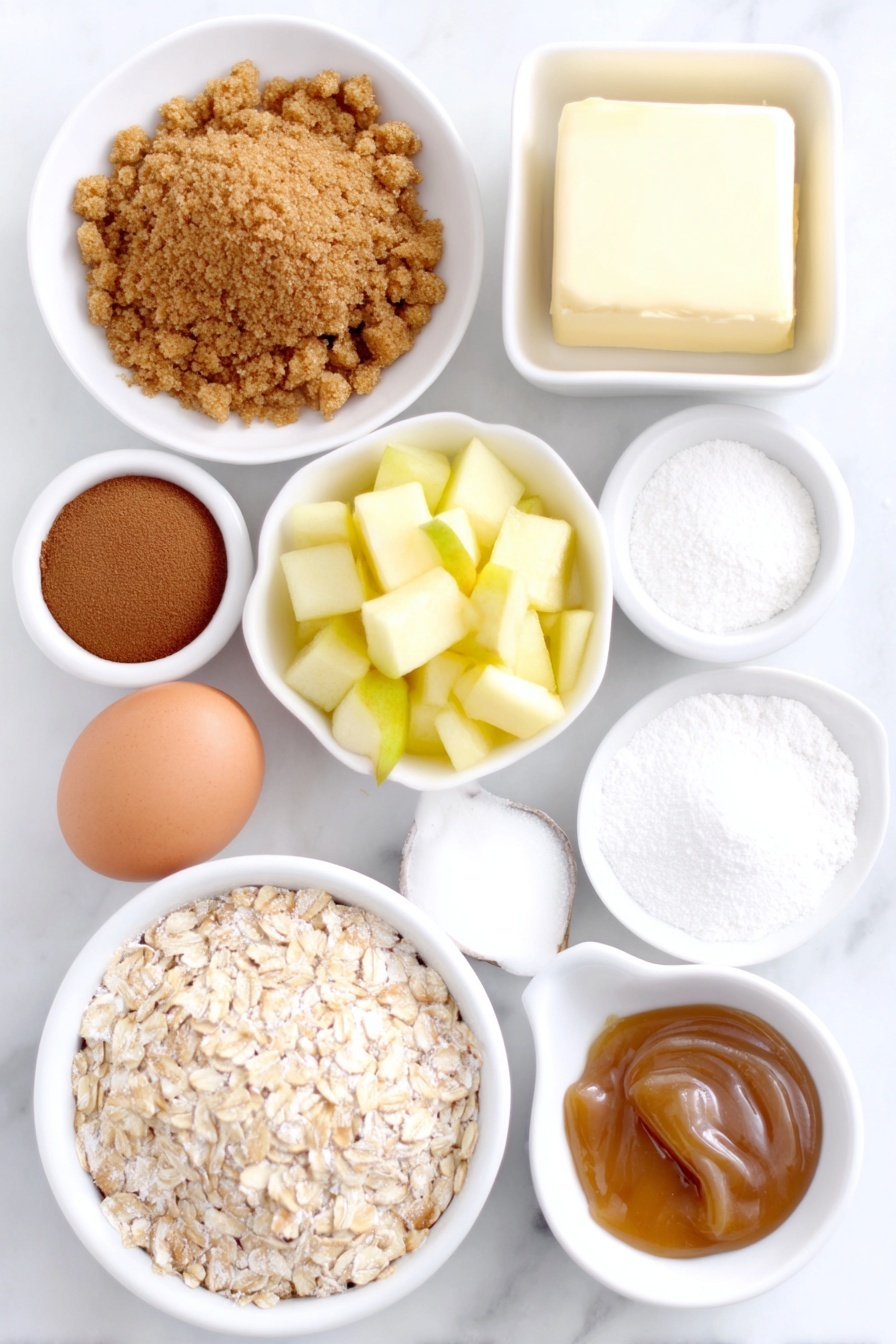 Apple Crisp Cheesecake Miniatures, fall dessert ideas, bite-sized cheesecake recipes, apple dessert recipes, easy mini cheesecake treats - Flat lay of a small pile of golden graham cracker crumbs, a neat mound of light brown sugar, a sprinkle of ground cinnamon in a small white bowl, a few curls of melted unsalted butter in a white ceramic dish, a small bowl of all-purpose flour, a heap of quick-cooking oats, a white ceramic bowl with a dusting of ground nutmeg, two medium-small peeled apples chopped finely, a small white ceramic bowl with freshly squeezed lemon juice, a block of soft cream cheese on a plain white plate, a clean whole brown egg, a small white bowl with granulated sugar, a small white bowl of vanilla extract, a small white bowl of cornstarch, and a white ceramic dish with golden caramel sauce placed on a clean white marble surface, soft natural light, photo taken with an iPhone, professional food photography style, fresh ingredients, white ceramic bowls, no bottles, no duplicates, no utensils, no packaging --ar 2:3 --v 7 --p m7354615311229779997