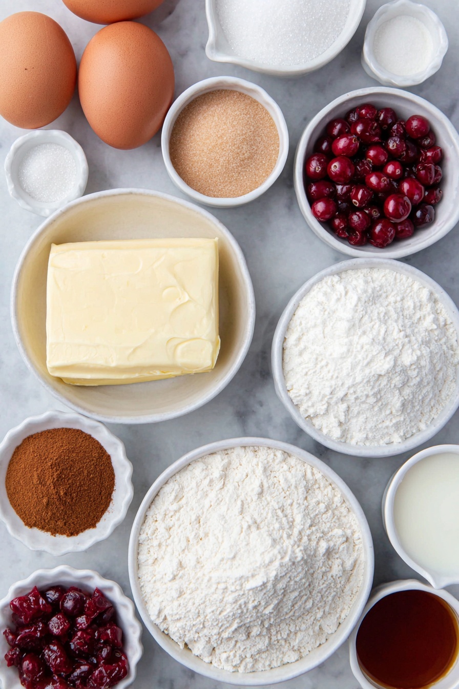 Cranberry Crumble Bars, cranberry bars recipe, holiday dessert bars, easy cranberry dessert, fruit crumble bars - Flat lay of fresh unsalted butter in a small white ceramic bowl, two brown eggs with clean shells, a small white bowl filled with granulated sugar, a small white bowl of light brown packed sugar, a small white bowl of sifted powdered sugar, a small white bowl of all-purpose flour, a small white bowl of baking powder, a small white bowl of ground cinnamon, a small white bowl of kosher salt, a small white bowl of cornstarch, a handful of fresh bright red cranberries, a few strands of orange zest next to a small white bowl of fresh orange juice, a small white bowl of vanilla extract, and a small white bowl of whole milk, all evenly spaced and arranged symmetrically on a clean white marble surface, soft natural light, photo taken with an iPhone, professional food photography style, fresh ingredients, white ceramic bowls, no bottles, no duplicates, no utensils, no packaging --ar 2:3 --v 7 --p m7354615311229779997