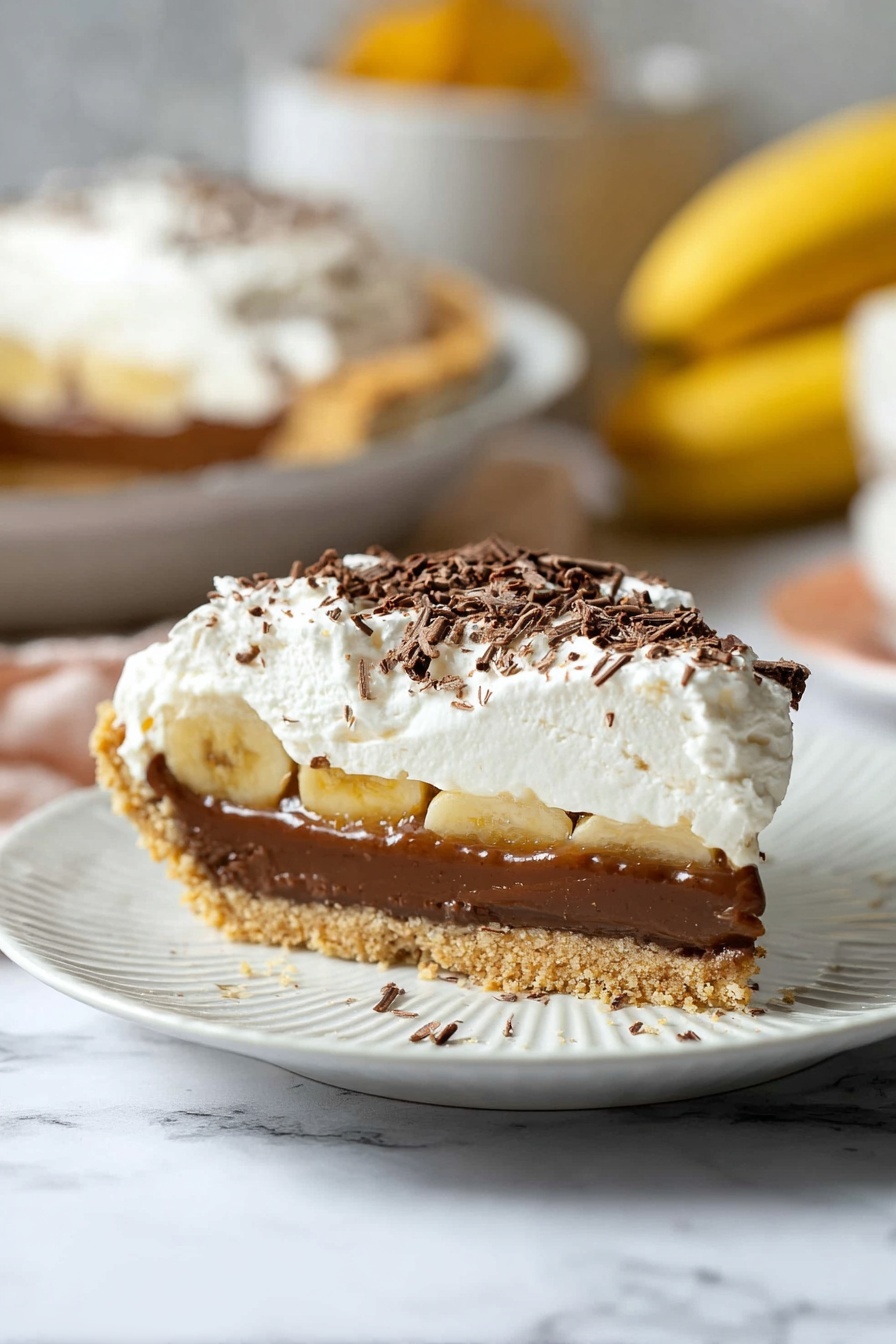 Banoffee Pie with Caramel and Bananas, banana caramel dessert, easy banoffee pie recipe, no-bake banoffee pie, layered banana dessert - The image shows a slice of pie on a white plate with ridged edges, placed on a white marbled surface. The pie has four layers: at the bottom is a crumbly, light brown crust; above it is a thick, smooth, dark brown chocolate layer; then a thin layer of caramel with slice pieces visible inside; and on top is a thick, fluffy white cream layer sprinkled lightly with dark brown chocolate shavings. The background is softly blurred, showing more pie and some bananas. Photo taken with an iphone --ar 2:3 --v 7