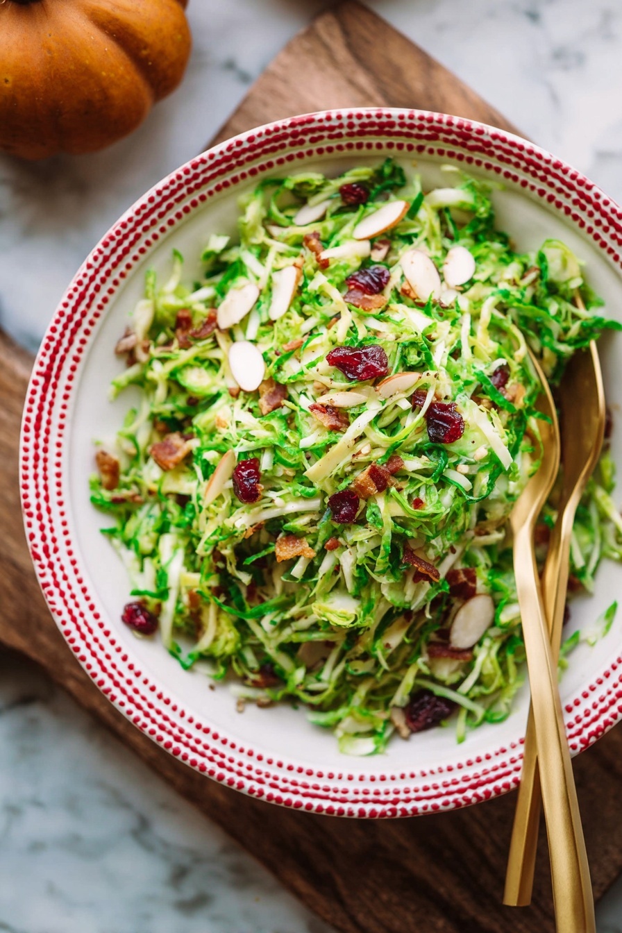 Brussels Sprouts Kale Apple Salad with Bacon, healthy Brussels sprouts salad, easiest kale apple salad, savory bacon apple salad, crunchy Brussels sprouts and kale salad - A wooden bowl filled with a shredded green salad showing thin layers of light green and pale yellow textures from the shaved Brussels sprouts. There are visible small pieces of dark red dried cranberries and bits of brown nuts mixed throughout the salad. Bright green leafy bits are scattered across all layers, adding a fresh and crisp look. Two gold forks rest inside the bowl, one leaning on the side. The bowl is placed on a white marbled surface with a few fresh Brussels sprouts and apples nearby, along with part of an orange checkered cloth. Photo taken with an iphone --ar 2:3 --v 7