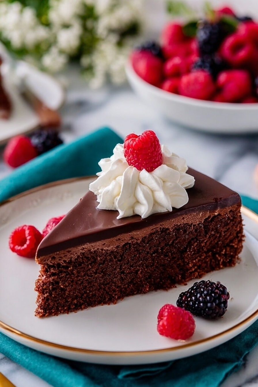 Flourless Chocolate Cake with Ganache, gluten-free chocolate cake, decadent chocolate dessert, easy flourless chocolate cake, rich chocolate ganache cake - A dark chocolate cake with smooth, shiny chocolate glaze covers the top and drips slightly over the edges. The cake is a single layer, round in shape, and sits on a clear glass cake stand. On the center of the cake, a small bunch of fresh red raspberries and black blackberries sit on top, adding bright color and texture. Around the cake, more blackberries are scattered on a white marbled surface, with a burgundy cloth nearby and a white plate with cutlery in the background. Photo taken with an iphone --ar 2:3 --v 7